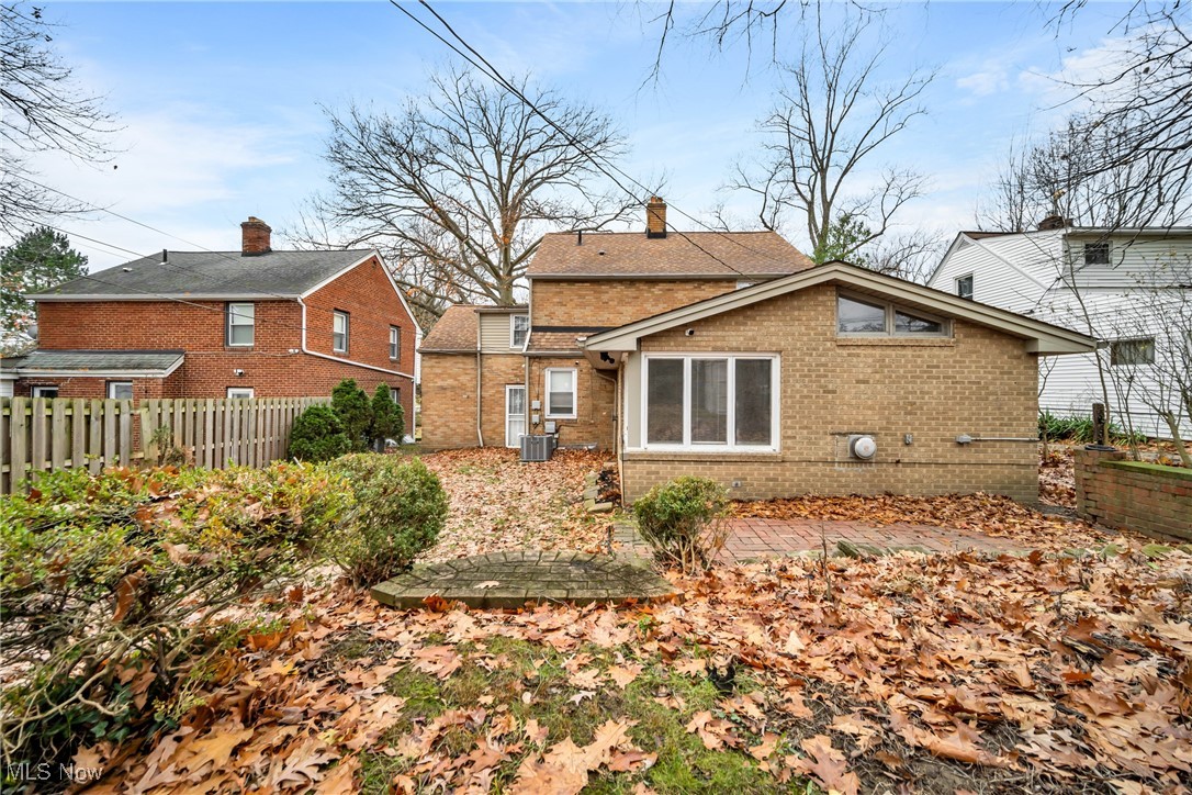 1605 Laclede Road Cleveland, OH 44121 - Photo 39 of 40 Rear view of house with fence, brick siding, and central AC