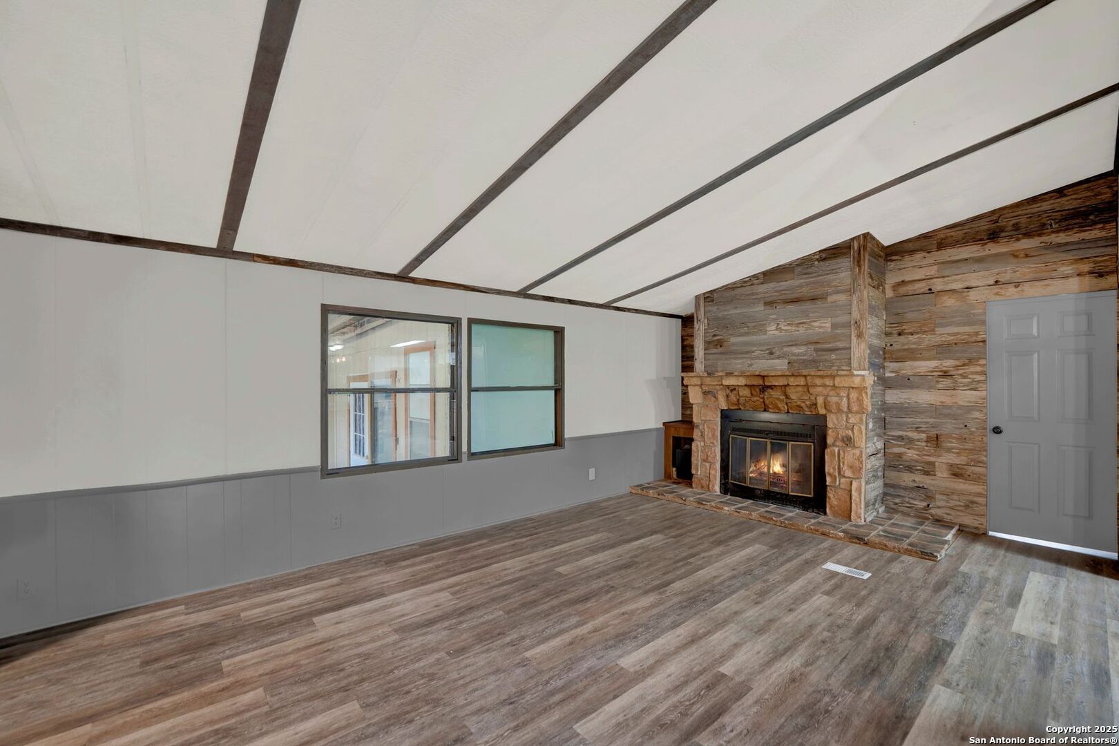 245 Bandera Drive Bandera, TX 78003 - Photo 11 of 37 a view of an empty room with a fireplace and a window