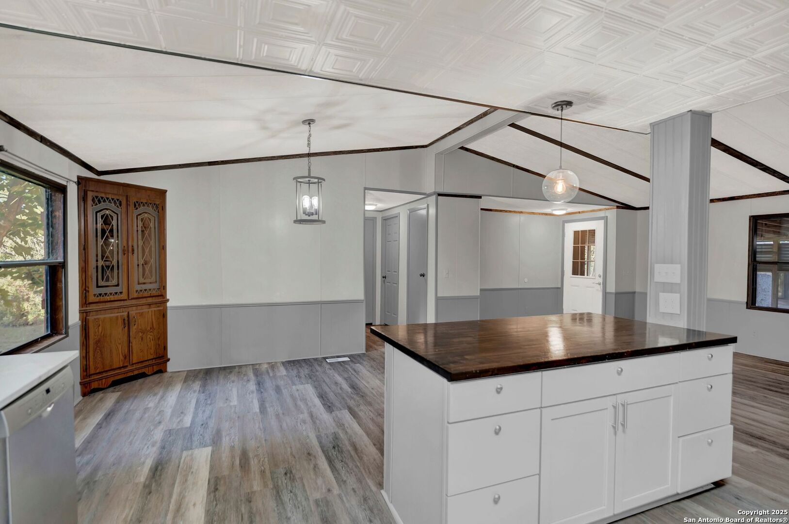 245 Bandera Drive Bandera, TX 78003 - Photo 15 of 37 a kitchen with kitchen island a counter top space wooden floor and stainless steel appliances