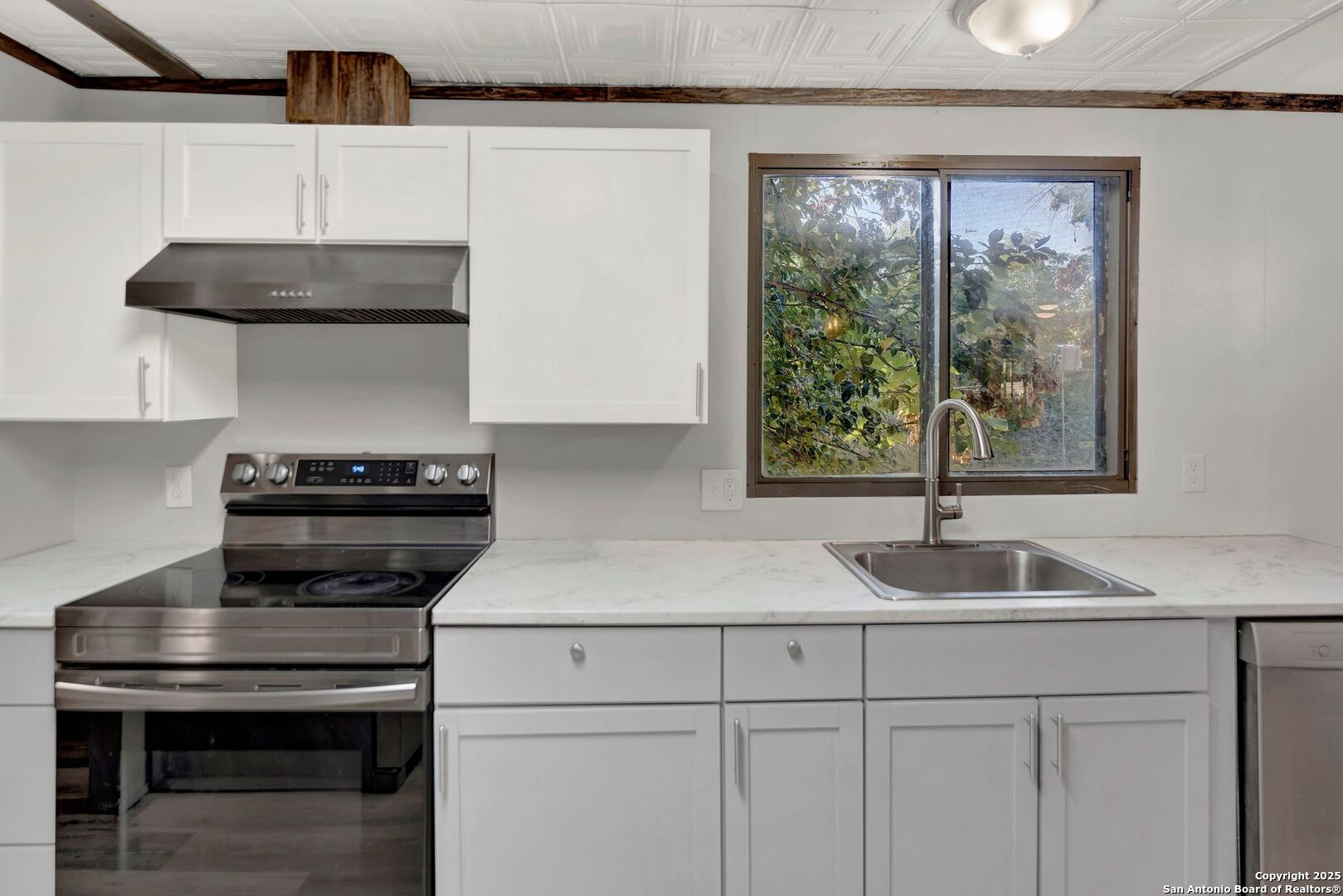 245 Bandera Drive Bandera, TX 78003 - Photo 16 of 37 a kitchen with a sink a stove and cabinets