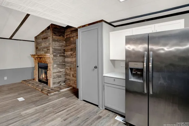 a view of small space with wooden floor and entrance