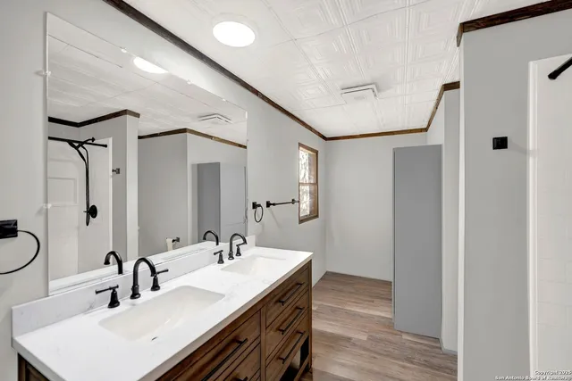 a bathroom with a granite countertop sink and a mirror