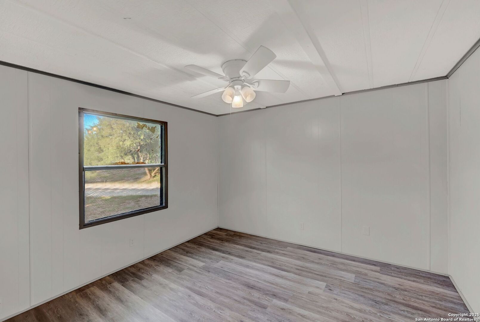 245 Bandera Drive Bandera, TX 78003 - Photo 26 of 37 wooden floor in an empty room with a window