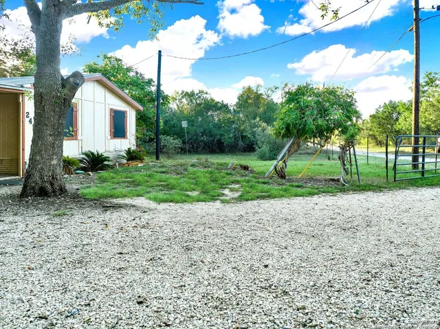 a view of a house with backyard and garden