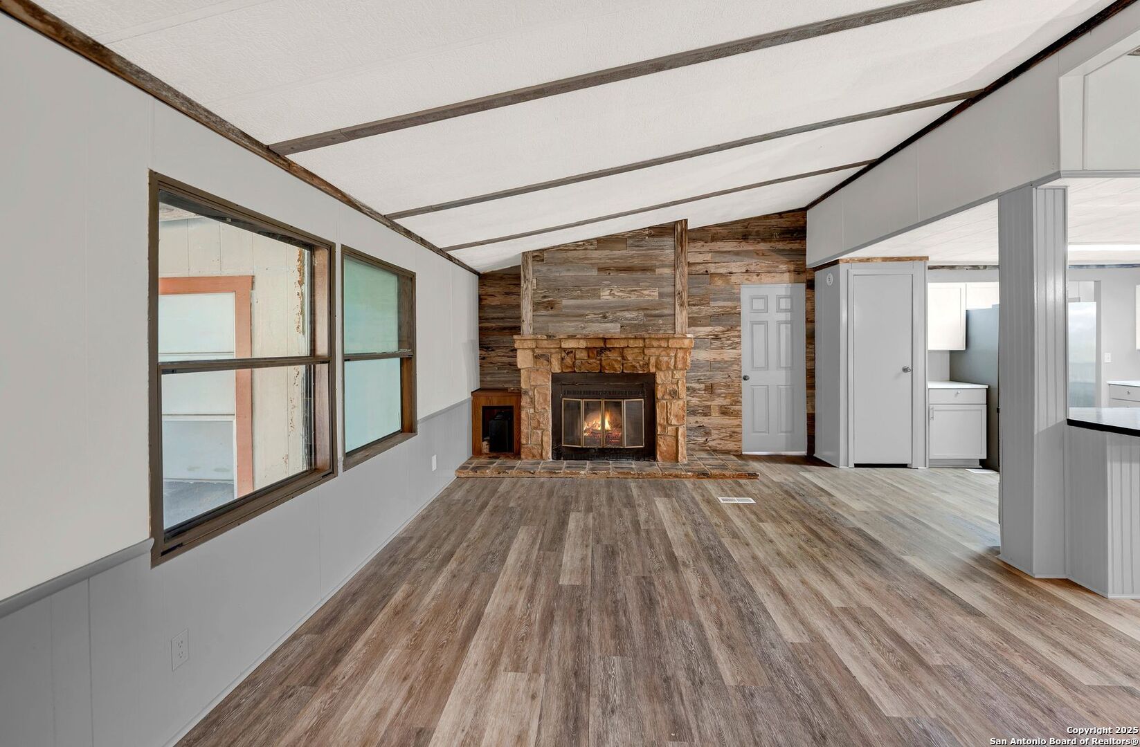 245 Bandera Drive Bandera, TX 78003 - Photo 9 of 37 a view of empty room with wooden floor and fireplace