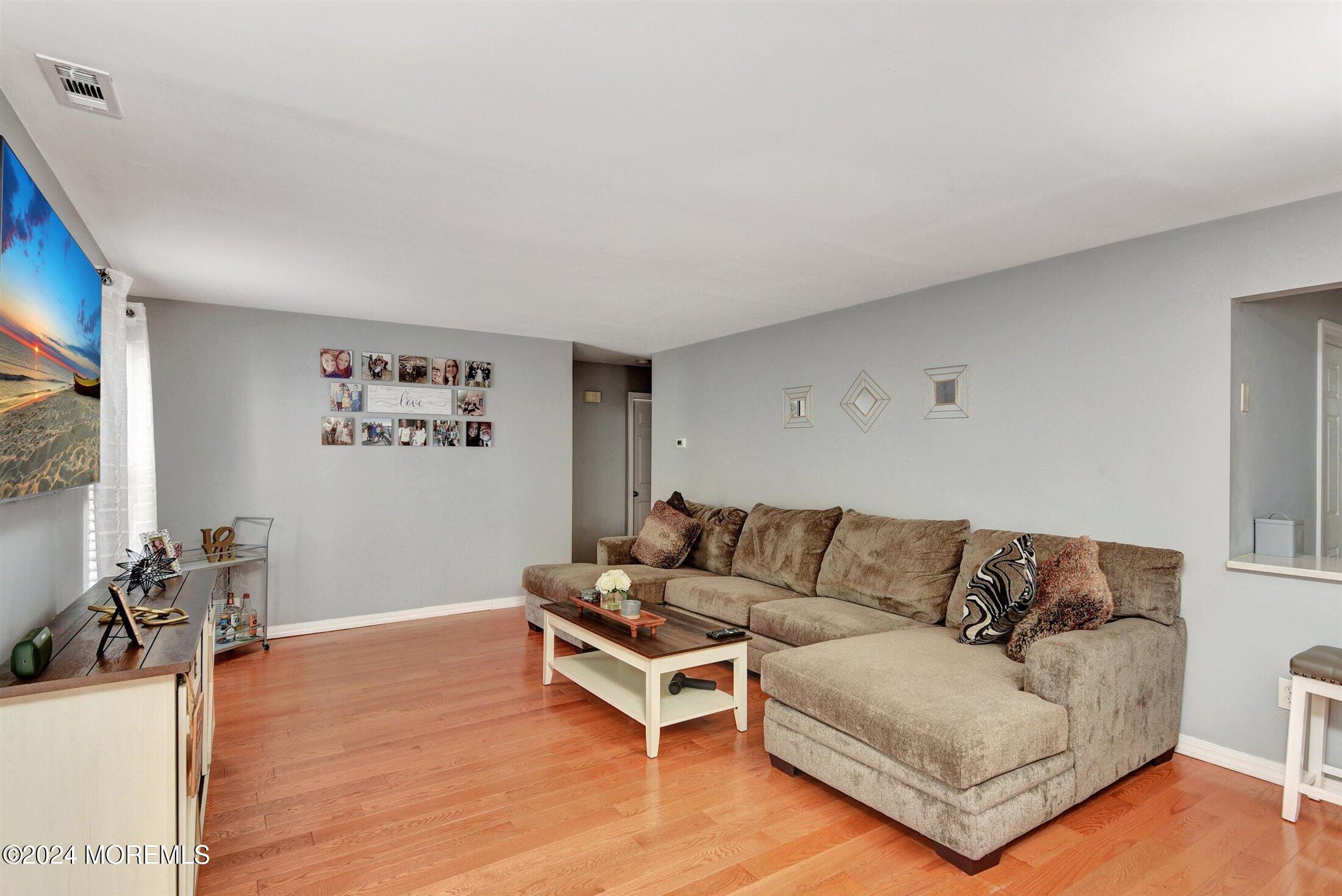503 Harding Road, Unit 1 Freehold, NJ 07728 - Photo 3 of 20 a living room with furniture and a flat screen tv