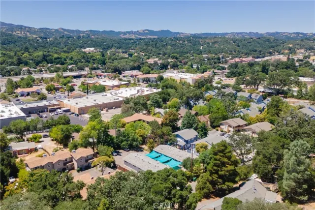 an aerial view of a house with a lot of trees