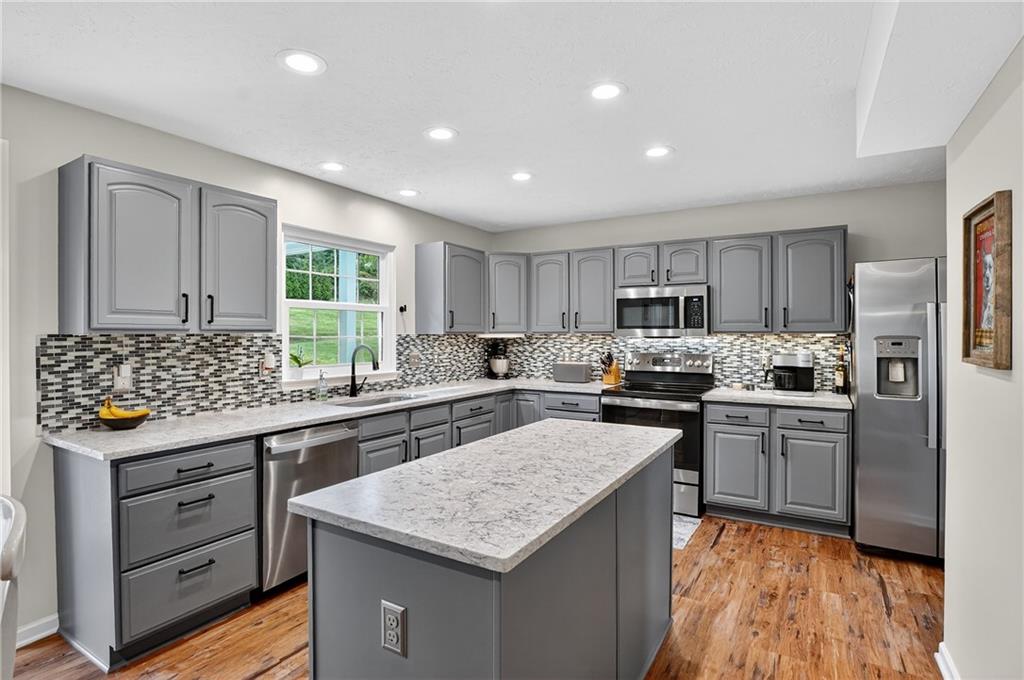 224 Field Club Circle McKees Rocks, PA 15136 - Photo 11 of 41 a kitchen with granite countertop kitchen island wooden cabinets and stainless steel appliances