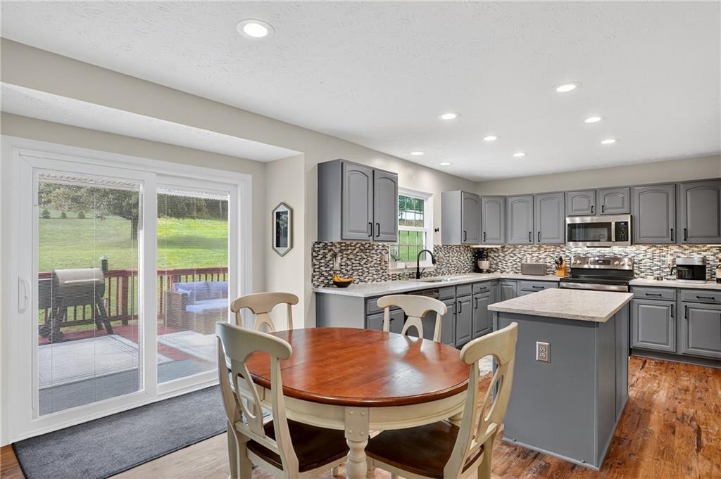 224 Field Club Circle McKees Rocks, PA 15136 - Photo 15 of 41 a kitchen with a dining table chairs and stove