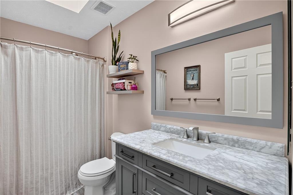 224 Field Club Circle McKees Rocks, PA 15136 - Photo 26 of 41 a bathroom with a granite countertop sink a toilet and a shower