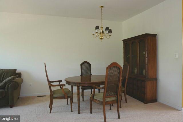 43191 Riders Square Broadlands, VA 20148 - Photo 13 of 21 a view of a dining room with furniture and chandelier