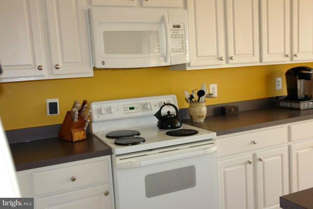 43191 Riders Square Broadlands, VA 20148 - Photo 8 of 21 a kitchen with white cabinets and appliances