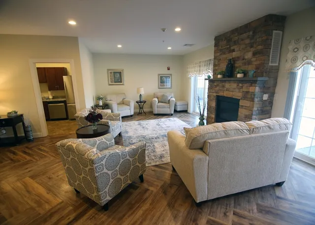 a living room with furniture and a fireplace