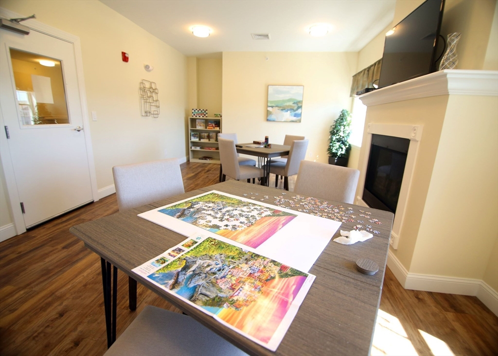 2 Regency Village Way, Unit 208 Merrimac, MA 01860 - Photo 5 of 19 a living room with furniture and a table