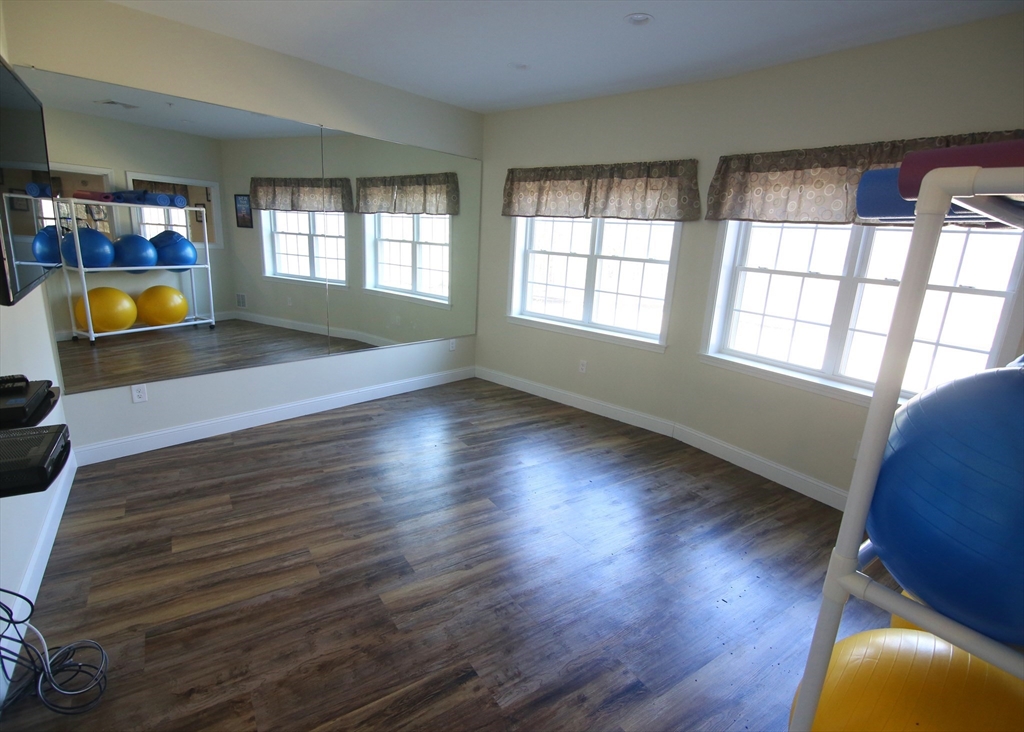 2 Regency Village Way, Unit 208 Merrimac, MA 01860 - Photo 7 of 19 wooden floor in an empty room with a window