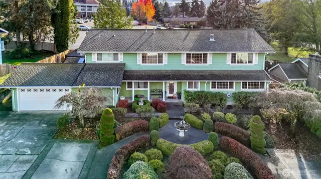 a front view of a house with garden and porch