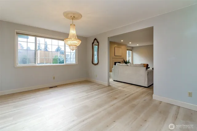 a living room with furniture a large window and a fireplace