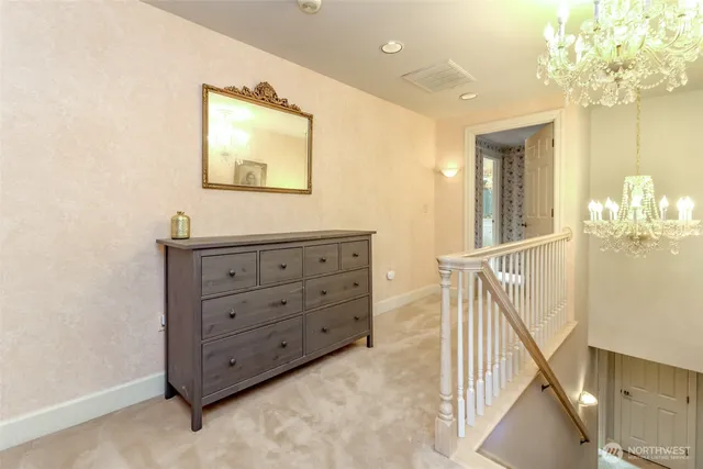 en view of a hallway view with wooden floor and staircase
