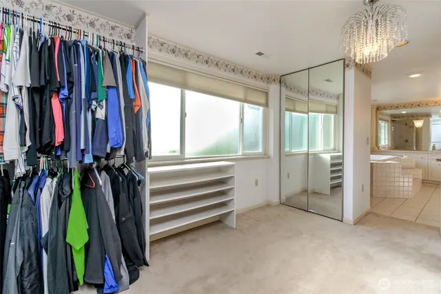 a bedroom with a large bed and a night stand