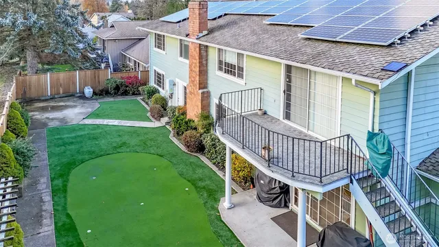 a front view of house with yard and outdoor seating