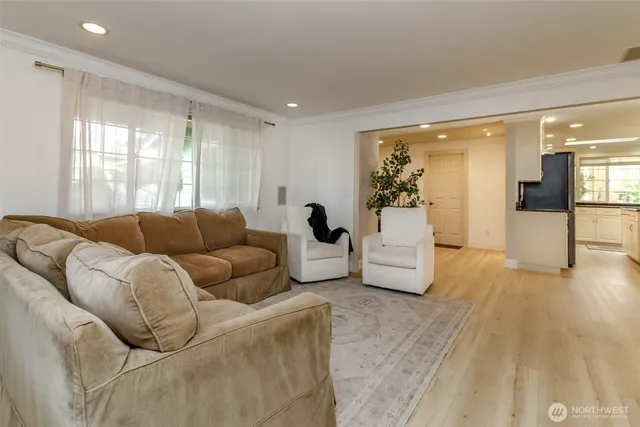 a dining room with furniture a chandelier and wooden floor