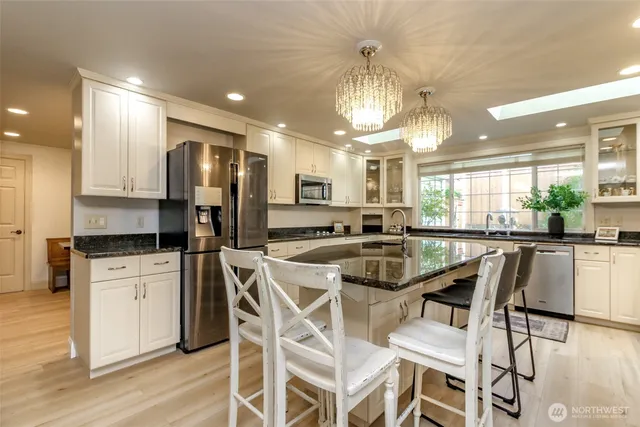 a dining room with furniture and chandelier
