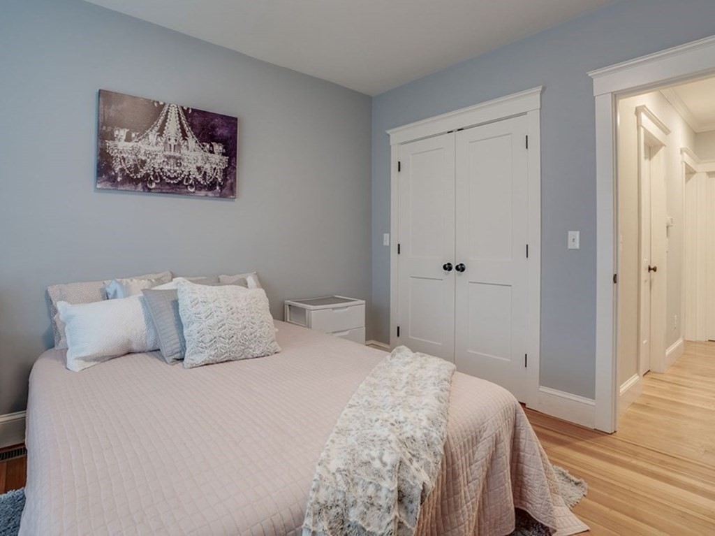 11 Fletcher Road, Unit 11 Bedford, MA 01730 - Photo 12 of 31 a bedroom with a bed and a painting on the wall