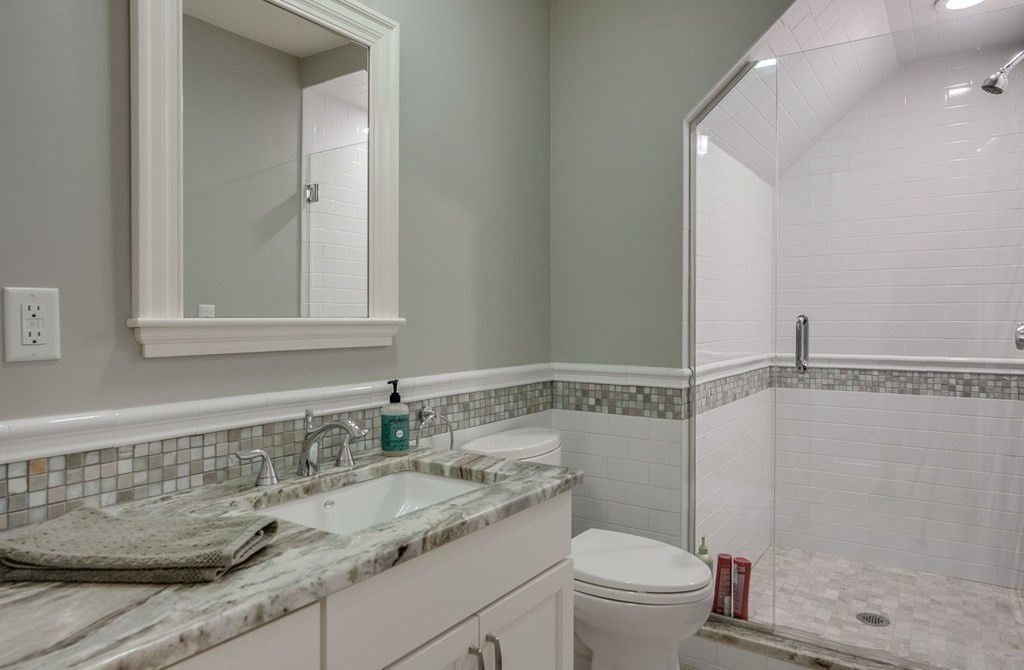 11 Fletcher Road, Unit 11 Bedford, MA 01730 - Photo 13 of 31 a bathroom with a granite countertop sink toilet and shower