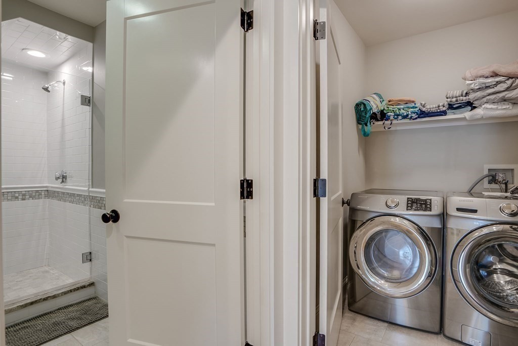 11 Fletcher Road, Unit 11 Bedford, MA 01730 - Photo 14 of 31 a view of a hallway with washer and dryer