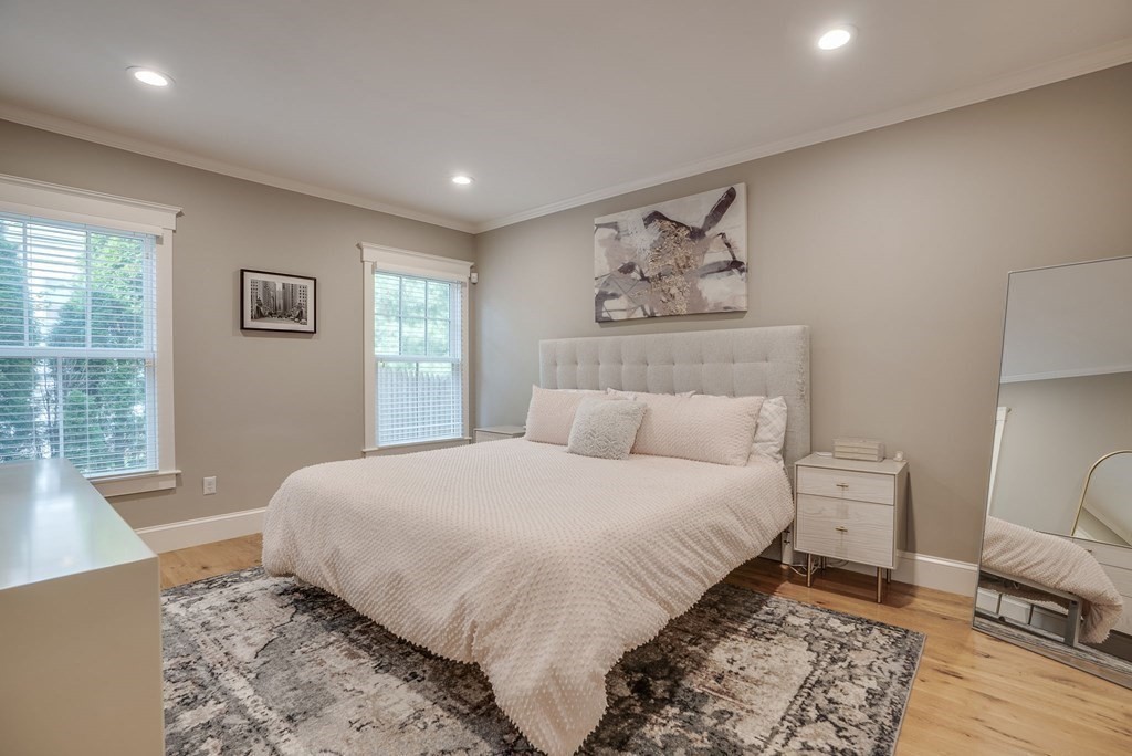 11 Fletcher Road, Unit 11 Bedford, MA 01730 - Photo 17 of 31 a bedroom with a large bed and a couch
