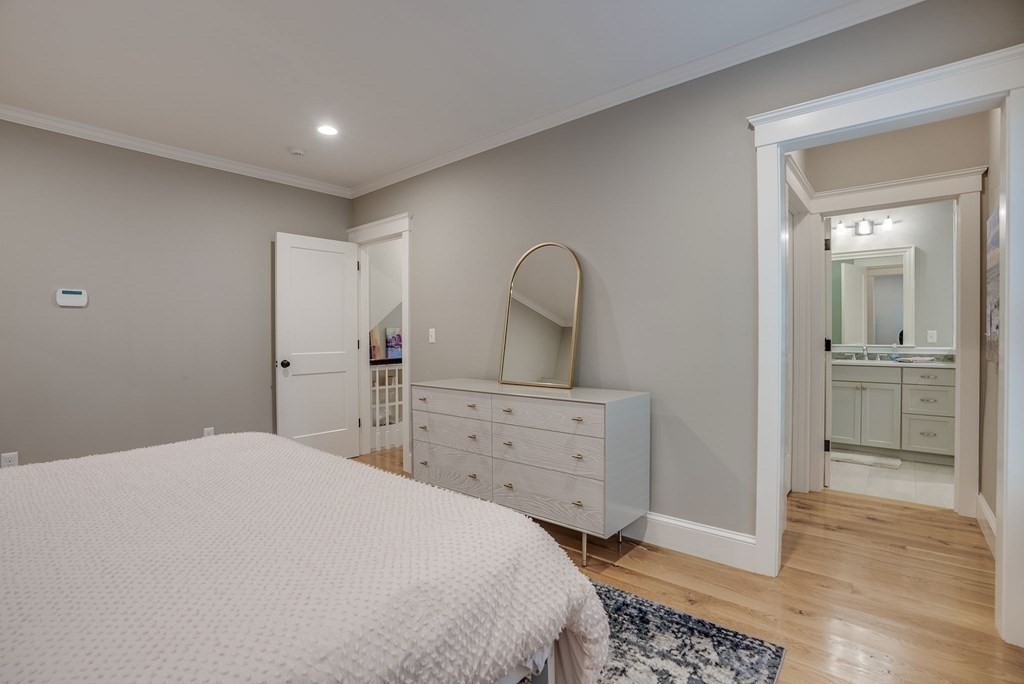 11 Fletcher Road, Unit 11 Bedford, MA 01730 - Photo 18 of 31 a bedroom with a bed and a dresser