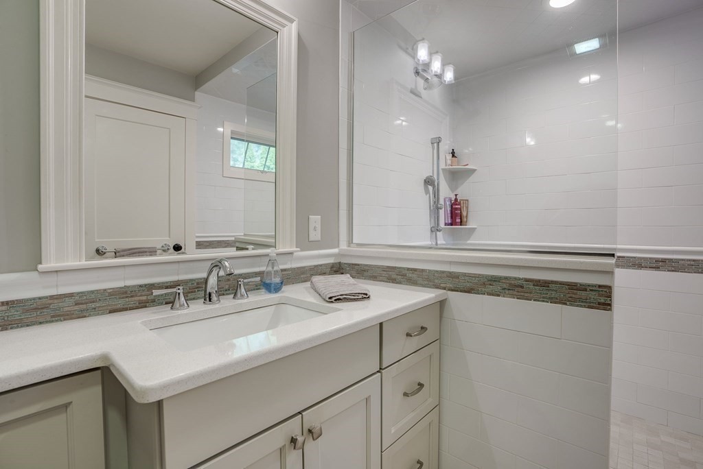 11 Fletcher Road, Unit 11 Bedford, MA 01730 - Photo 19 of 31 a bathroom with a sink vanity and mirror