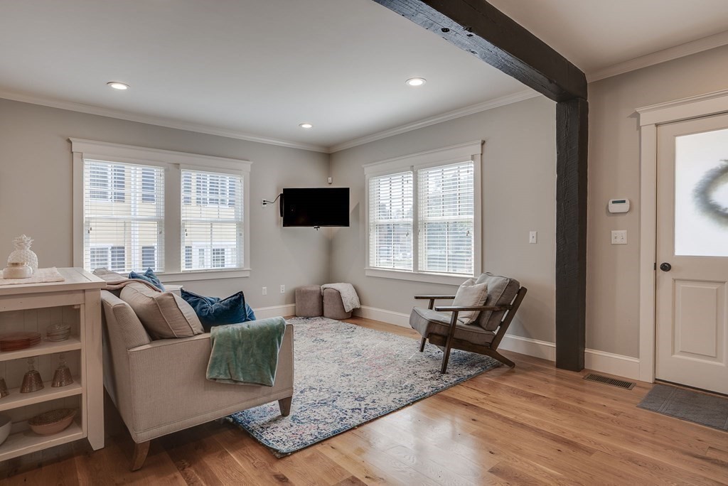 11 Fletcher Road, Unit 11 Bedford, MA 01730 - Photo 5 of 31 a living room with furniture and a flat screen tv
