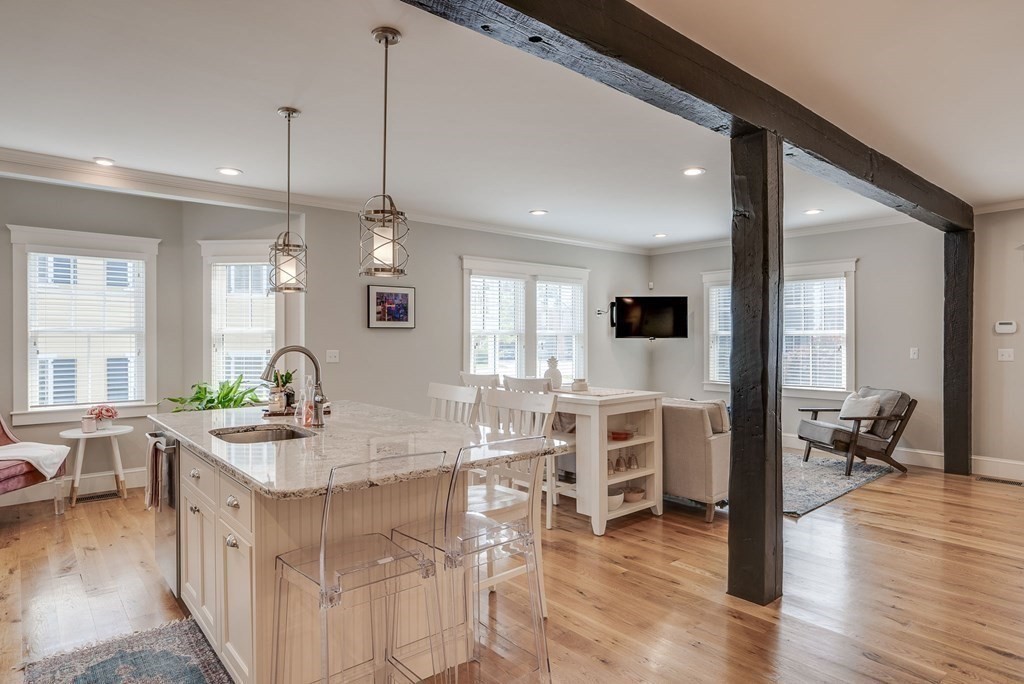 11 Fletcher Road, Unit 11 Bedford, MA 01730 - Photo 7 of 31 a kitchen with stainless steel appliances kitchen island granite countertop a stove and white cabinets with wooden floor