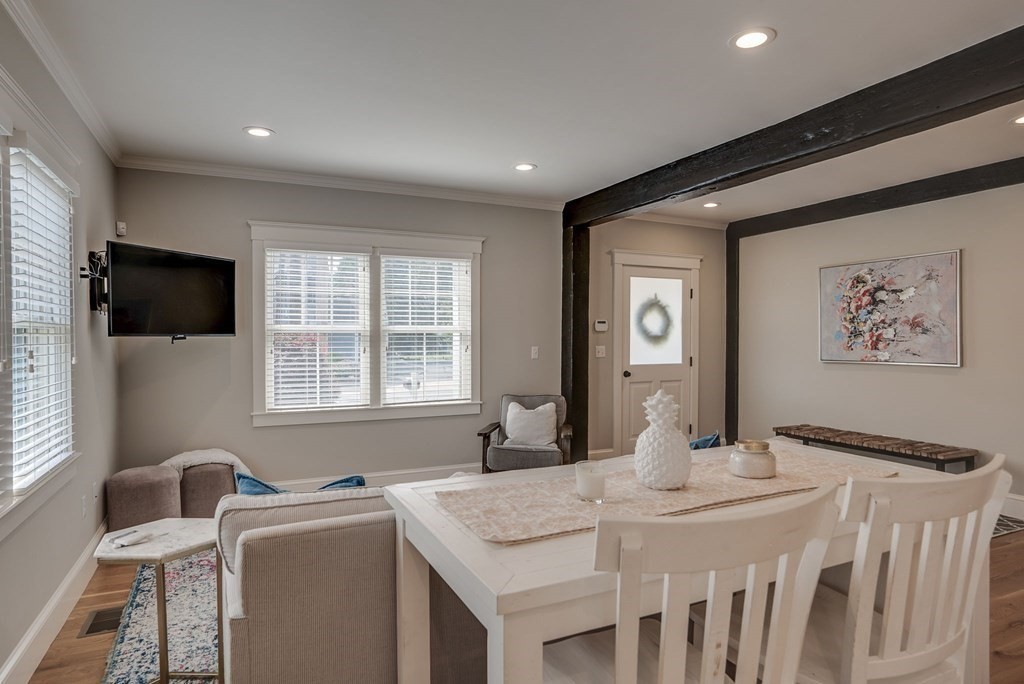 11 Fletcher Road, Unit 11 Bedford, MA 01730 - Photo 9 of 31 a view of a dining room with furniture window and wooden floor