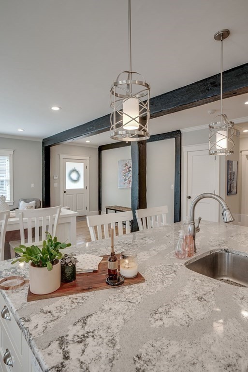 11 Fletcher Road, Unit 11 Bedford, MA 01730 - Photo 10 of 31 a very nice looking dining room with a chandelier