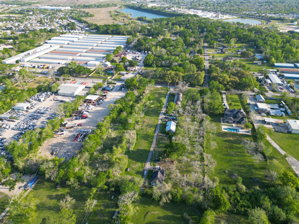 a aerial view of residential houses with outdoor space and trees