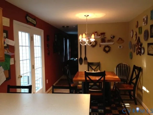 a view of a dining room with furniture and chandelier