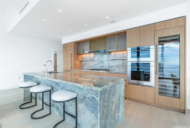 a kitchen with stainless steel appliances granite countertop a sink and a refrigerator