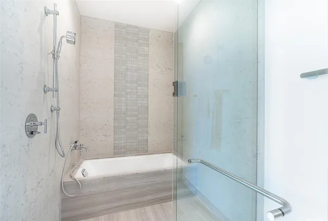 a bathroom with a tub and shower