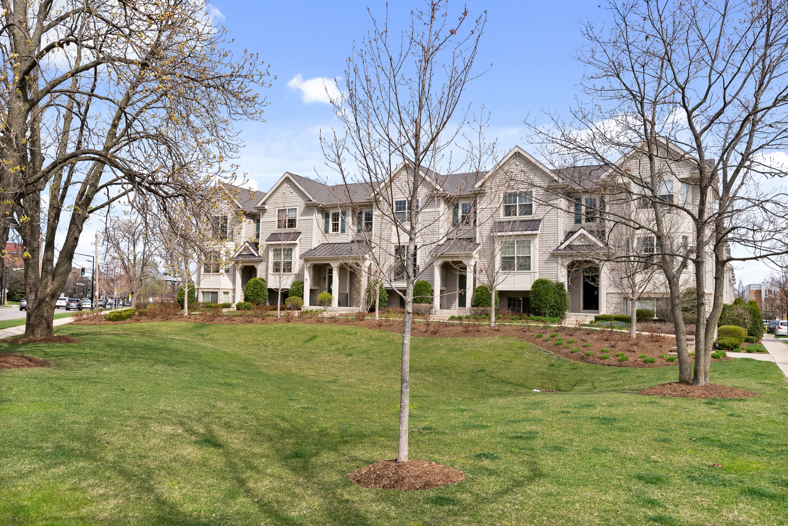 303 South NW Highway, Unit 2 Park Ridge, IL 60068 - Photo 2 of 30 a view of a big yard in front of a brick house with large windows