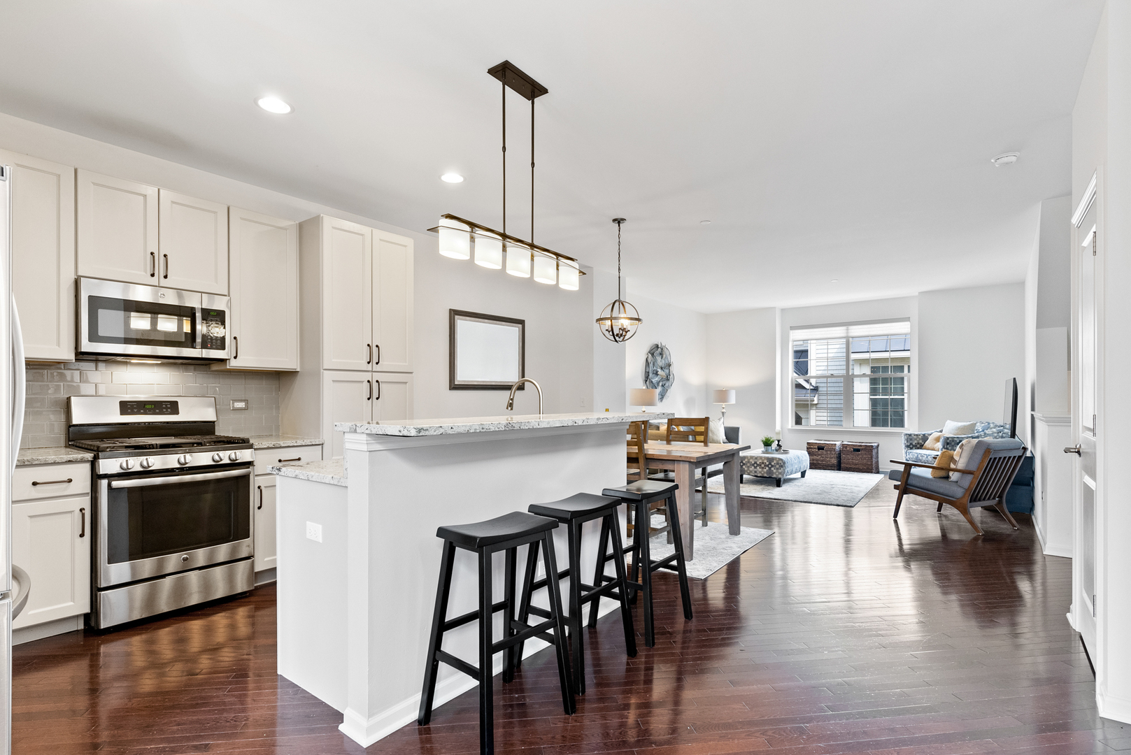 303 South NW Highway, Unit 2 Park Ridge, IL 60068 - Photo 8 of 30 a kitchen with stainless steel appliances granite countertop a stove a sink a microwave a dining table and chairs with wooden floor