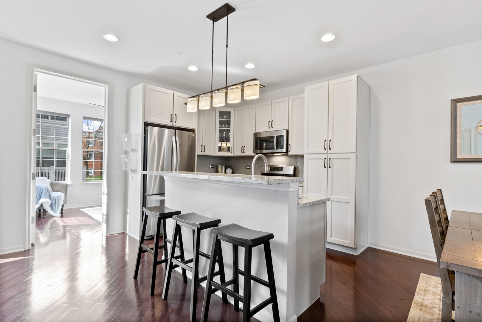 303 South NW Highway, Unit 2 Park Ridge, IL 60068 - Photo 10 of 30 a kitchen with stainless steel appliances a dining table chairs refrigerator and microwave