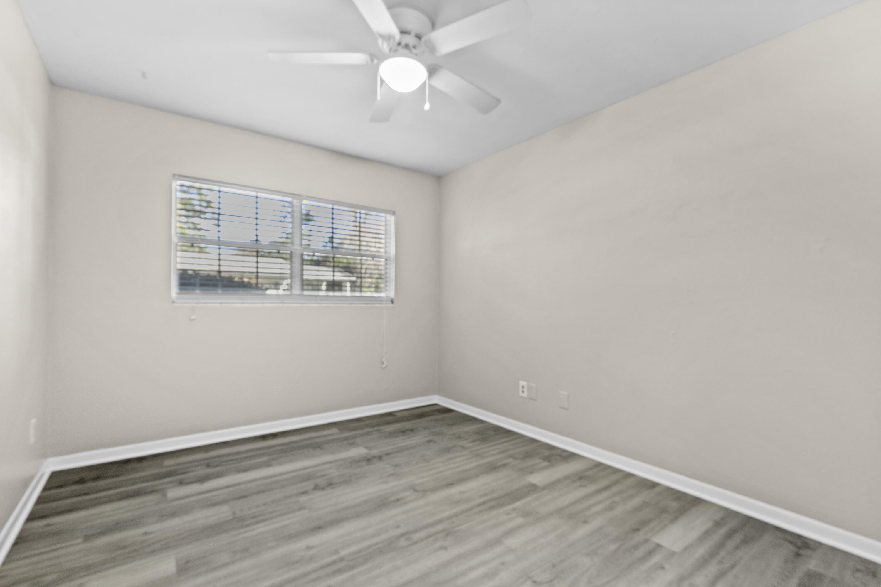 3331 Northwest 27th Avenue Gainesville, FL 32605 - Photo 23 of 29 wooden floor in an empty room with a window
