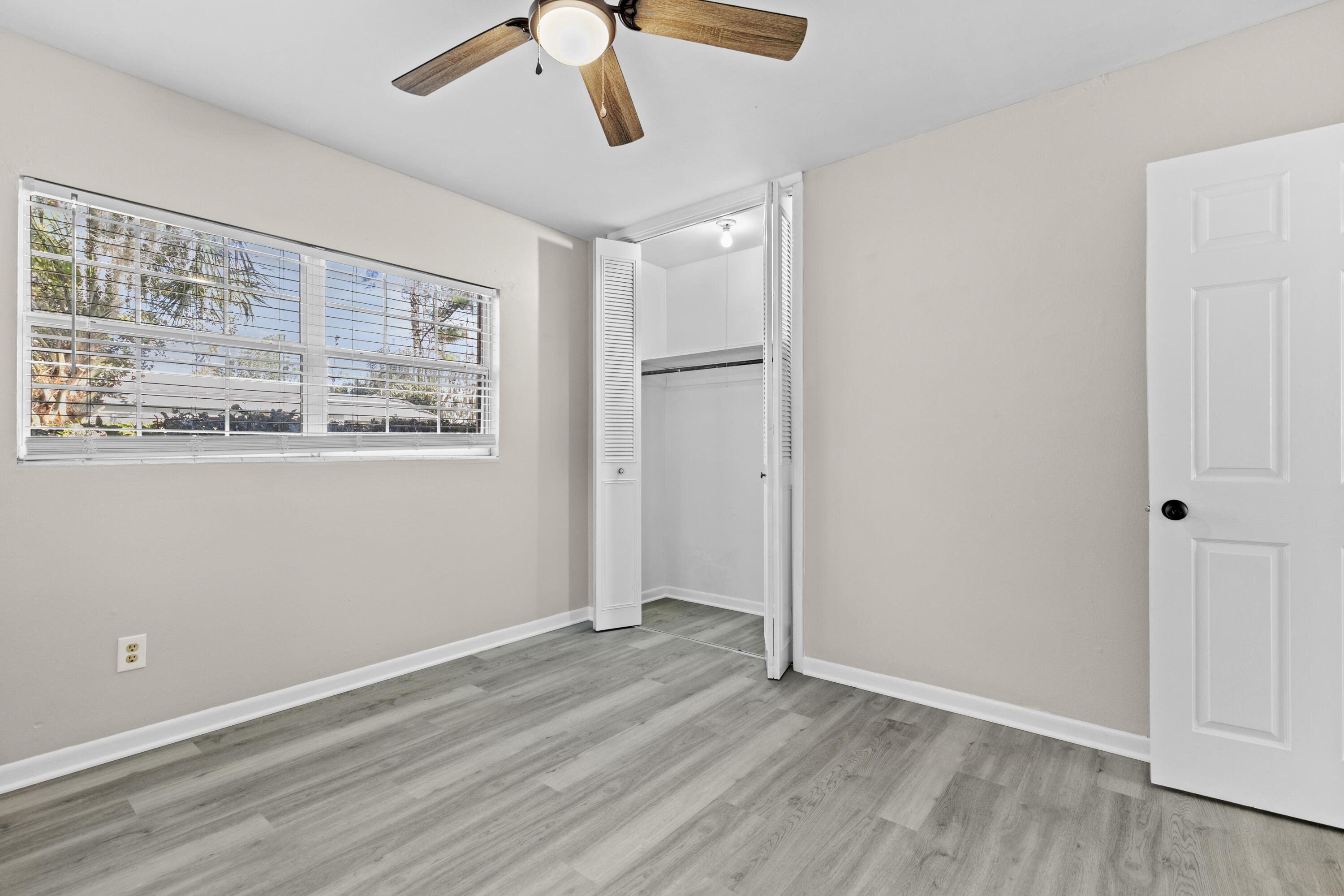 3331 Northwest 27th Avenue Gainesville, FL 32605 - Photo 28 of 29 a view of an empty room with wooden floor and a window