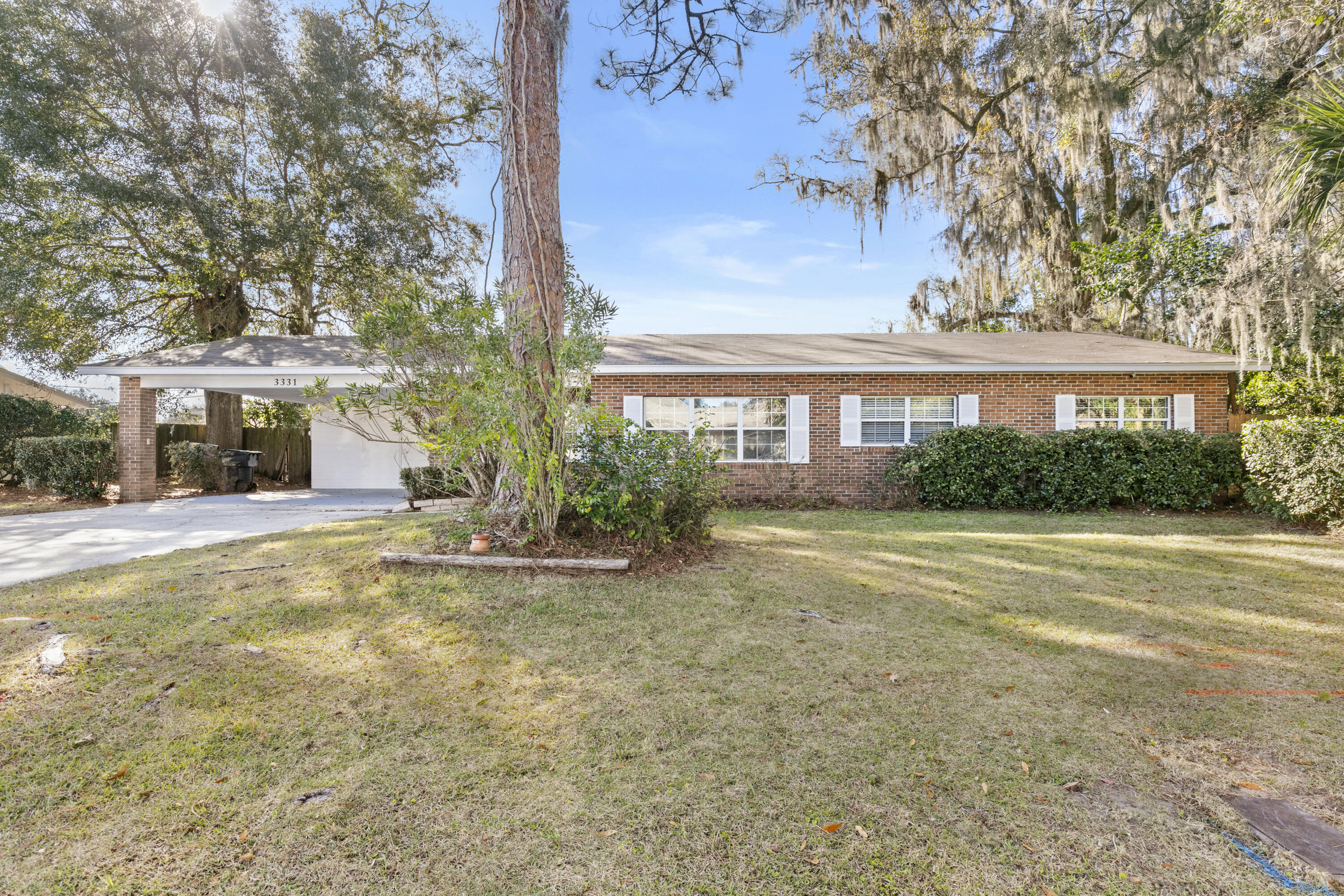 3331 Northwest 27th Avenue Gainesville, FL 32605 - Photo 3 of 29 a view of a house with a large tree and plants