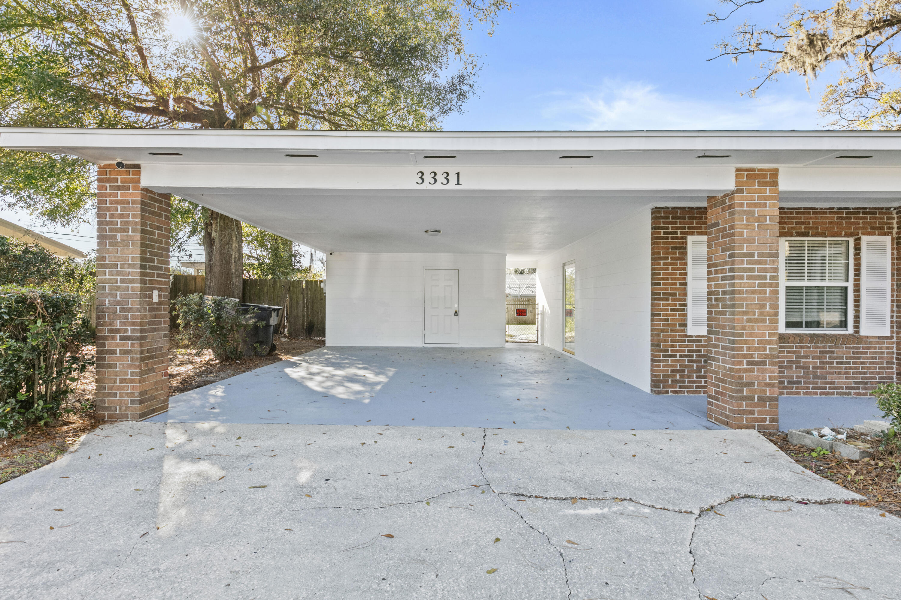 3331 Northwest 27th Avenue Gainesville, FL 32605 - Photo 5 of 29 a view of a hallway with wooden floor and a glass door