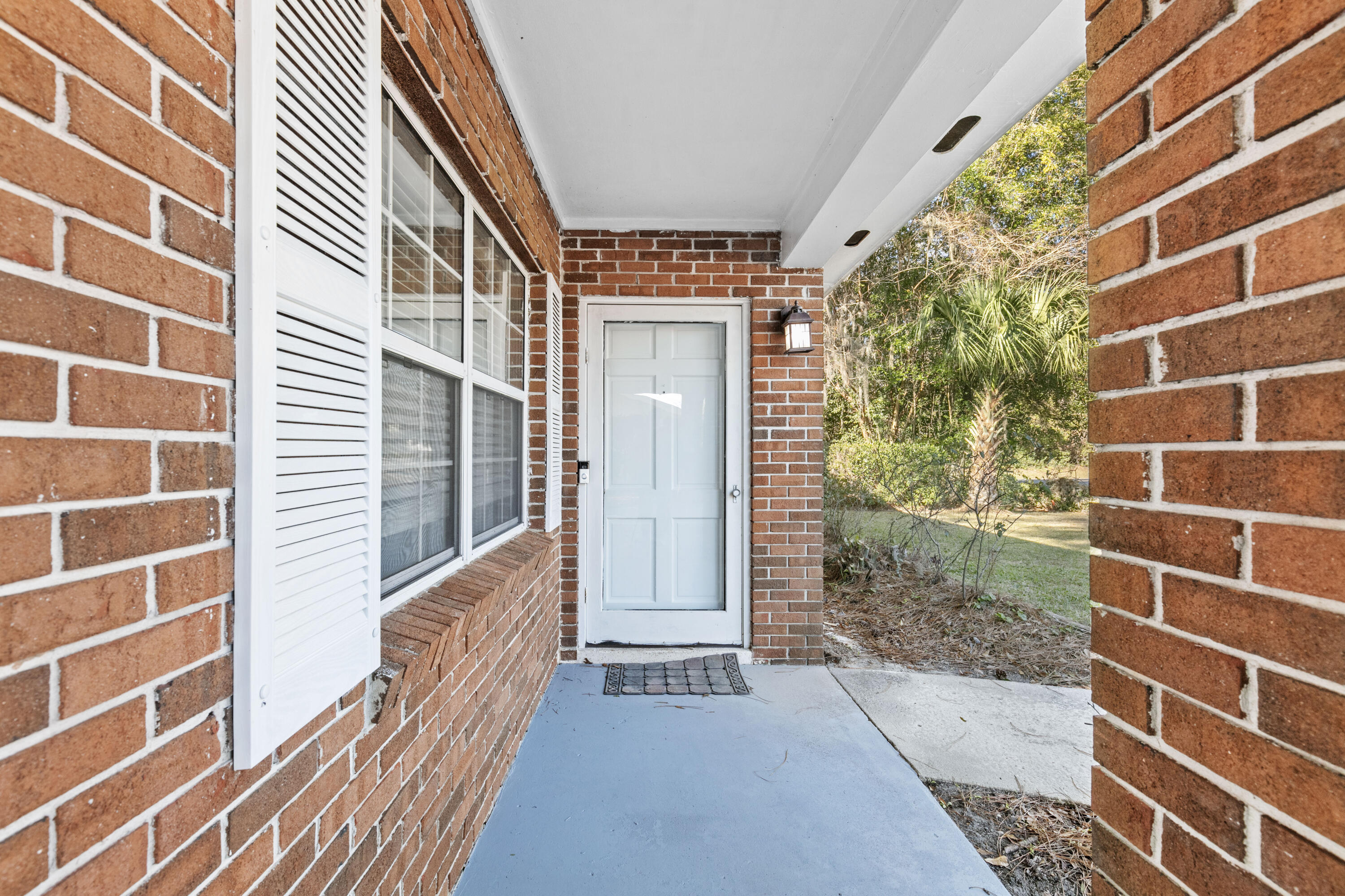 3331 Northwest 27th Avenue Gainesville, FL 32605 - Photo 6 of 29 a view of a brick house with a door