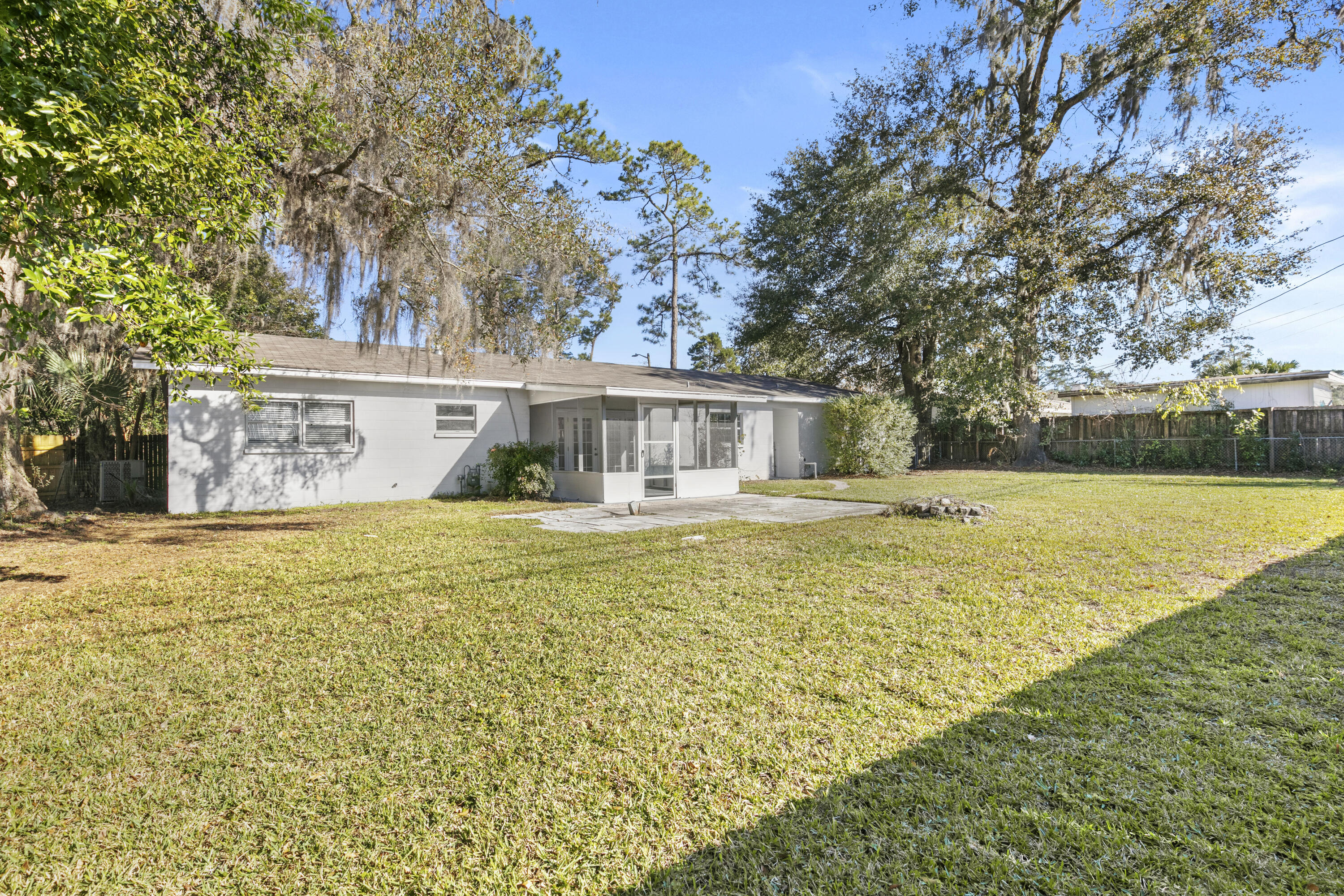 3331 Northwest 27th Avenue Gainesville, FL 32605 - Photo 9 of 29 a front view of a house with swimming pool and glass top