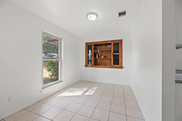 a view of an empty room with a ceiling fan